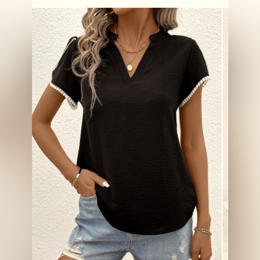 This blouse is a black patchwork short sleeve V neck blouse.